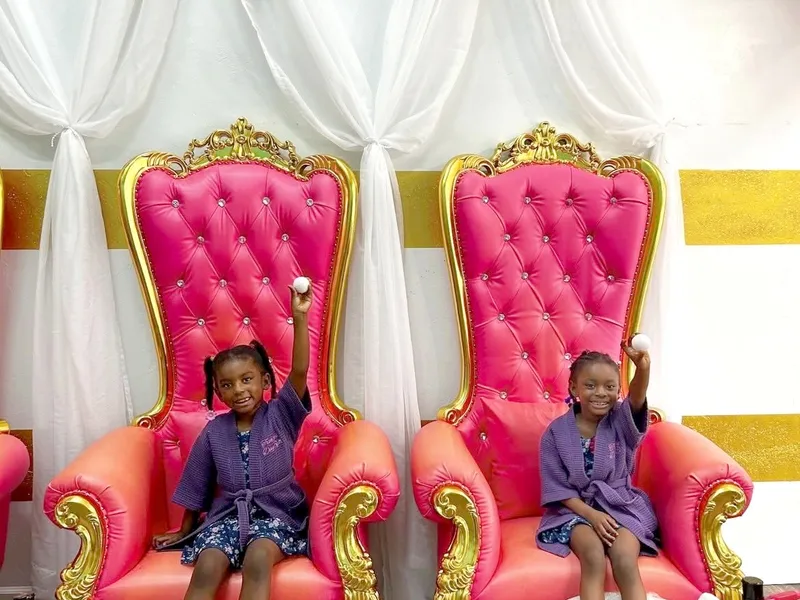 Two young friends smiling together in spa robes during a Trinity's Day Spa Best Friends Forever package visit