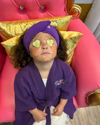 Child receiving an edible chocolate facial, one of Trinity's Day Spa's a la carte treats