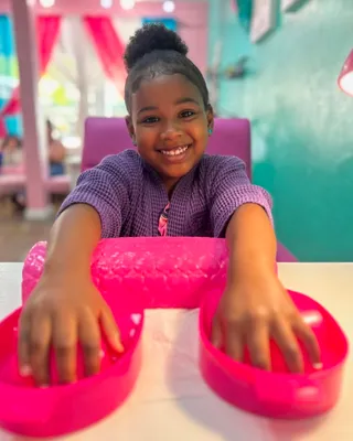 Little girl getting a colorful manicure as part of the Just Me spa package