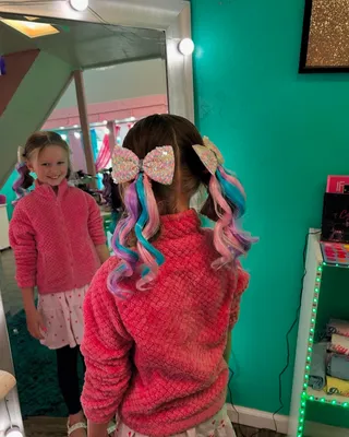 Child with vibrant rainbow-colored pigtails