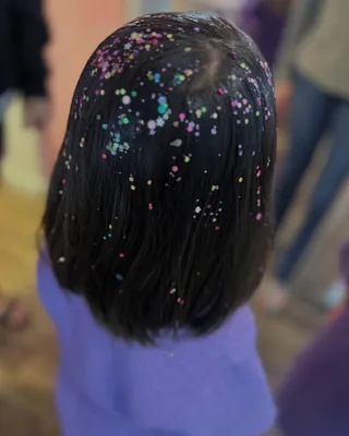 Child with sparkly glitter applied to her hair, the Sparkling Hair Fairies service